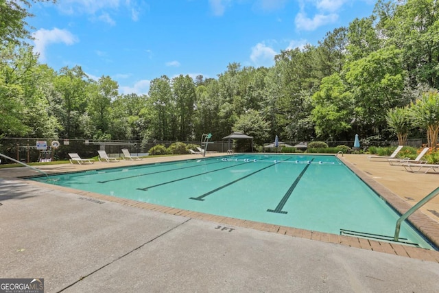 2535 Winthrope Way, Lawrenceville, GA 30044 - community pool featuring a patio area and view of scattered trees