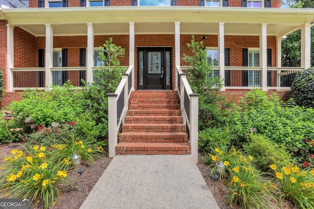 2535 Winthrope Way, Lawrenceville, GA 30044 - doorway to property featuring brick siding and covered porch