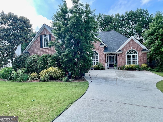 1902 Commons View Cir, Snellville, GA 30078 - traditional-style home with brick siding, a front yard, and a shingled roof