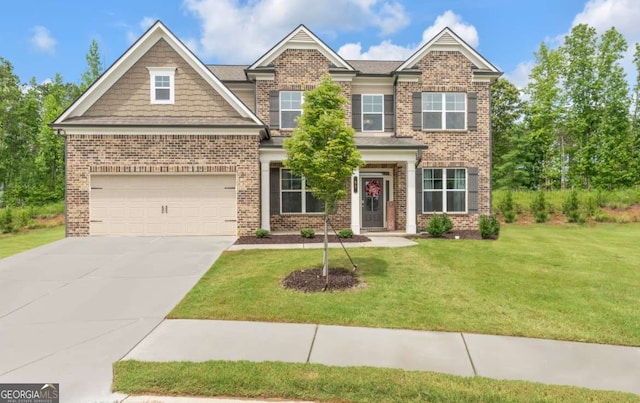 51 Waterfowl Ct, Jefferson, GA 30549 - craftsman-style home with brick siding, a garage, driveway, and a front yard