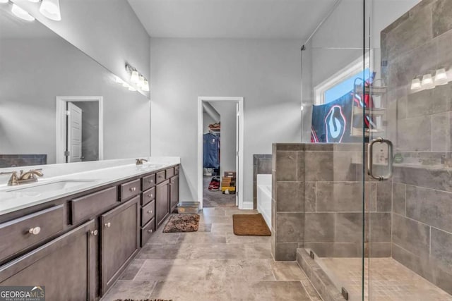 51 Waterfowl Ct, Jefferson, GA 30549 - full bath with double vanity, a stall shower, a bath, a spacious closet, and stone finish floors