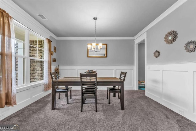 51 Waterfowl Ct, Jefferson, GA 30549 - dining room featuring dark colored carpet, crown molding, a chandelier, and a wainscoted wall