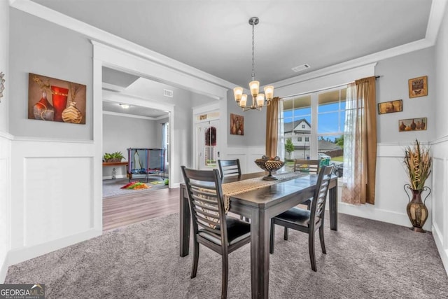51 Waterfowl Ct, Jefferson, GA 30549 - dining space with a chandelier, carpet floors, ornamental molding, and wainscoting