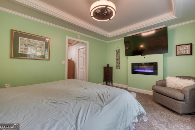 311 Lonesome Pine Trl, Blairsville, GA 30512 - carpeted bedroom featuring crown molding, a glass covered fireplace, a tray ceiling, and baseboards