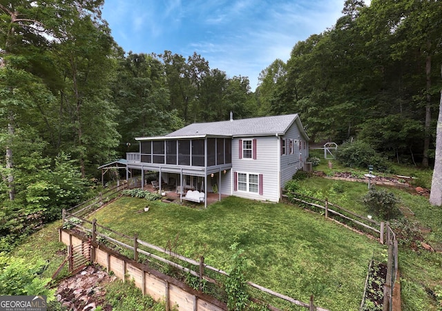 311 Lonesome Pine Trl, Blairsville, GA 30512 - back of house with a sunroom, a vegetable garden, a yard, and a wooded view