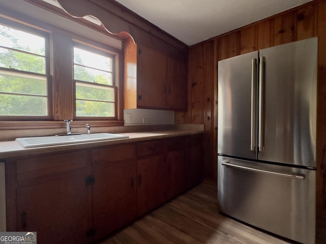 4 Walton Way NW, Rome, GA 30165 - kitchen featuring freestanding refrigerator, a sink, brown cabinets, wood finished floors, and wooden walls