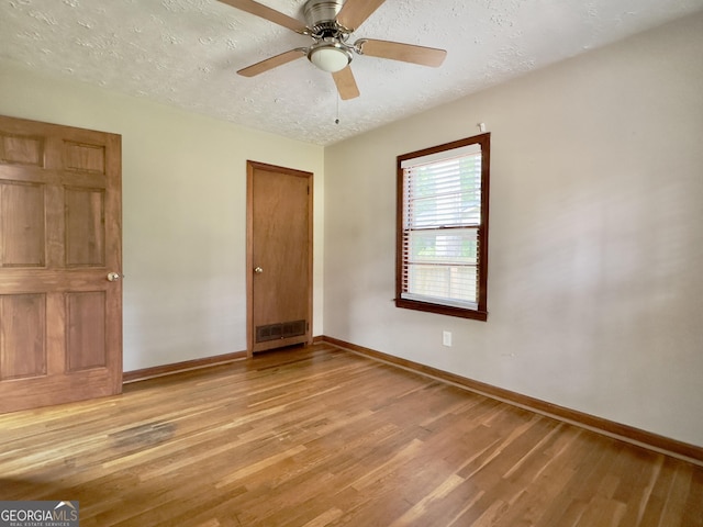 4 Walton Way NW, Rome, GA 30165 - unfurnished bedroom featuring wood finished floors, baseboards, a textured ceiling, and a ceiling fan