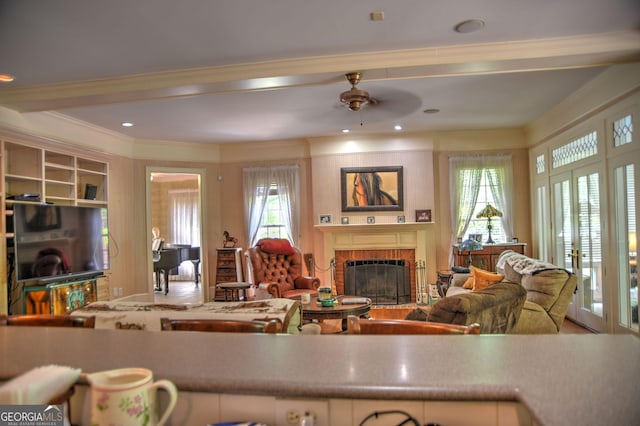 12001 Layfield Rd, Upatoi, GA 31829 - living room featuring a fireplace, crown molding, ceiling fan, and plenty of natural light