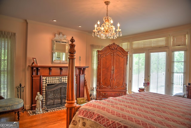 12001 Layfield Rd, Upatoi, GA 31829 - bedroom with access to outside, a chandelier, wood finished floors, crown molding, and a fireplace