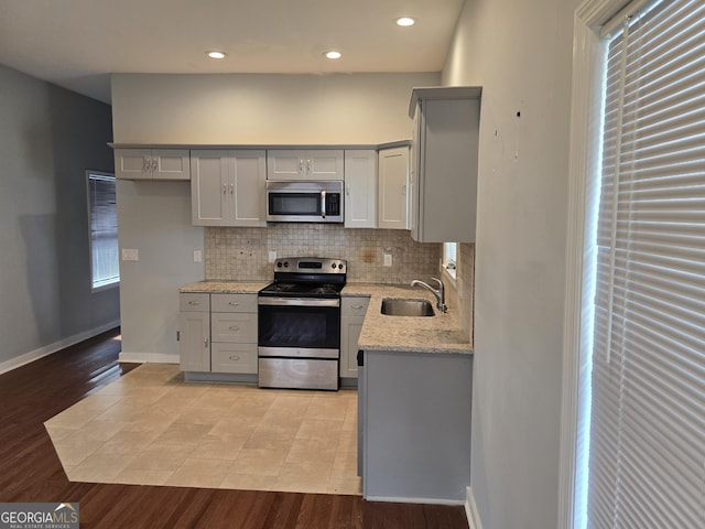 490 Rockwell St SW, Atlanta, GA 30310 - kitchen featuring appliances with stainless steel finishes, gray cabinetry, tasteful backsplash, light stone countertops, and recessed lighting