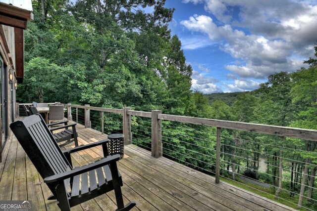 190 Toccoa Heights Rd, Blue Ridge, GA 30513 - wooden terrace featuring a view of trees and outdoor dining area