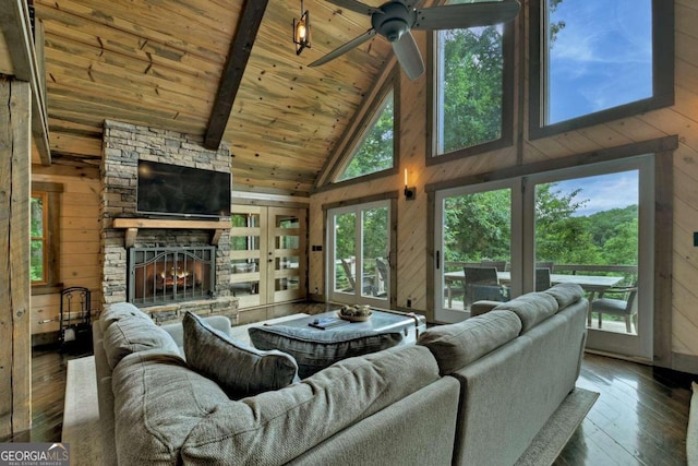 190 Toccoa Heights Rd, Blue Ridge, GA 30513 - living room with wood walls, wood ceiling with exposed beams, a stone fireplace, high vaulted ceiling, and a ceiling fan
