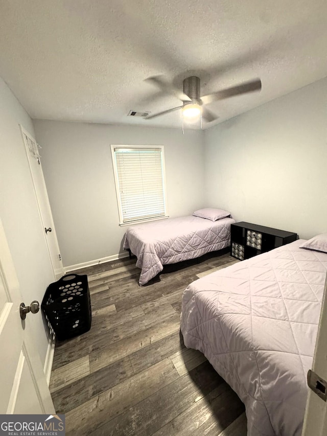 2220 Youth Monroe Rd, Monroe, GA 30655 - bedroom with a textured ceiling, wood finished floors, baseboards, and a ceiling fan