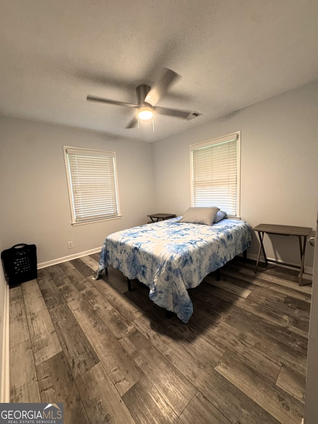 2220 Youth Monroe Rd, Monroe, GA 30655 - bedroom featuring dark wood-style floors, a textured ceiling, baseboards, and a ceiling fan