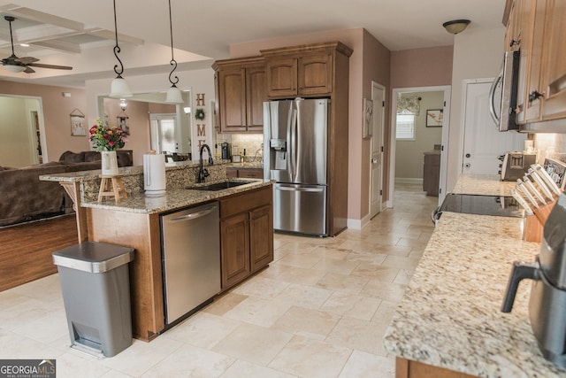 1325 Adams Rd, Meansville, GA 30256 - kitchen featuring stainless steel appliances, a sink, open floor plan, light stone counters, and a ceiling fan