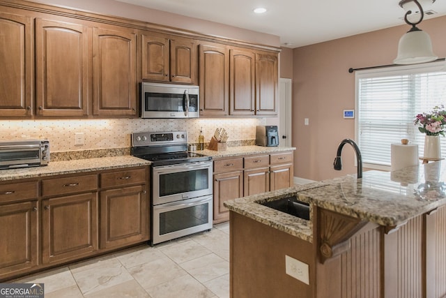 1325 Adams Rd, Meansville, GA 30256 - kitchen featuring appliances with stainless steel finishes, a sink, decorative backsplash, light stone counters, and recessed lighting