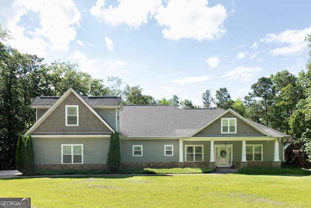 1325 Adams Rd, Meansville, GA 30256 - craftsman inspired home featuring a front lawn, stone siding, covered porch, and a shingled roof