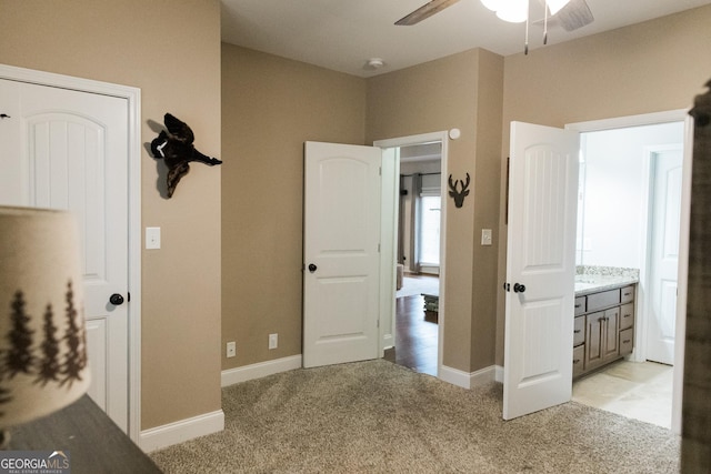 1325 Adams Rd, Meansville, GA 30256 - unfurnished bedroom featuring light colored carpet, baseboards, and a ceiling fan