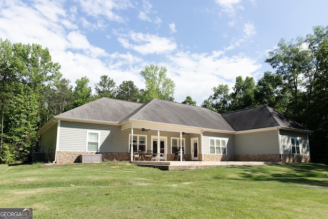 1325 Adams Rd, Meansville, GA 30256 - rear view of house featuring ceiling fan, stone siding, a yard, and central AC unit