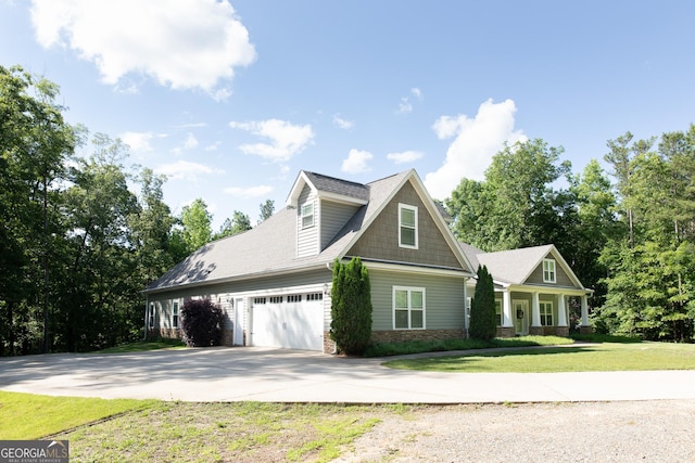 1325 Adams Rd, Meansville, GA 30256 - view of front facade with driveway, a front yard, stone siding, and an attached garage