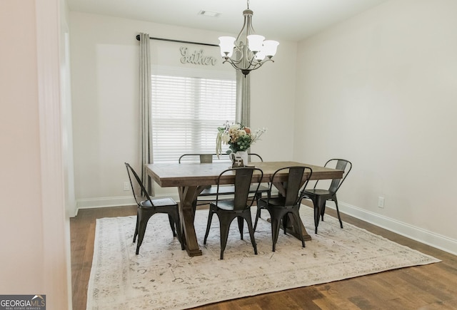 1325 Adams Rd, Meansville, GA 30256 - dining area featuring a chandelier, baseboards, and dark wood-style floors