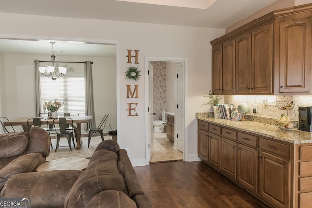 1325 Adams Rd, Meansville, GA 30256 - kitchen featuring a chandelier, dark wood-type flooring, light stone counters, and open floor plan