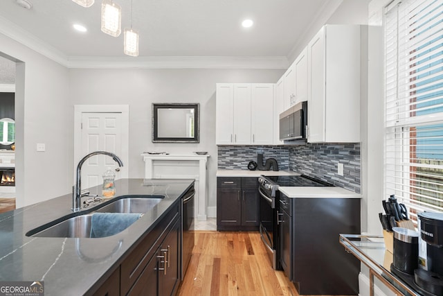 50 Ormond St SW, Atlanta, GA 30315 - kitchen with stainless steel appliances, a sink, white cabinets, plenty of natural light, and crown molding