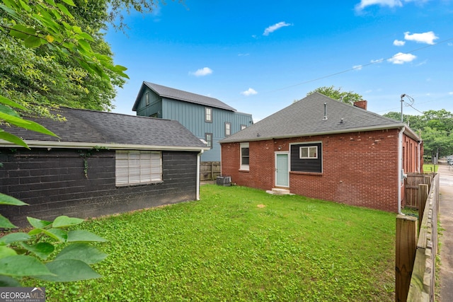 50 Ormond St SW, Atlanta, GA 30315 - rear view of property with entry steps, a chimney, brick siding, cooling unit, and roof with shingles