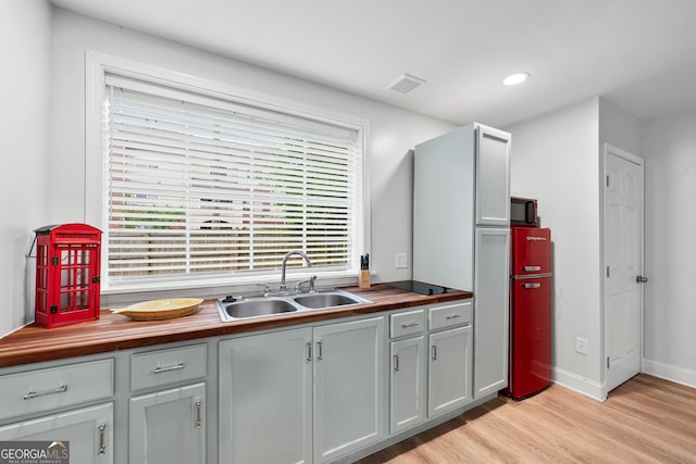 50 Ormond St SW, Atlanta, GA 30315 - kitchen with wooden counters, a sink, light wood-style flooring, baseboards, and recessed lighting