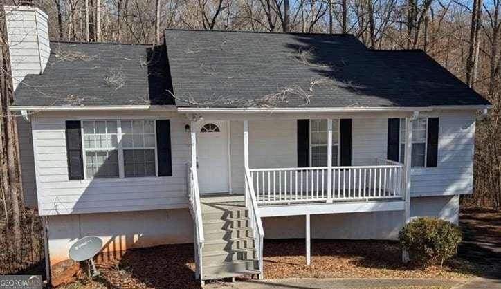 1668 Independence Dr, Douglasville, GA 30134 - view of front of property with a porch, a chimney, and stairway
