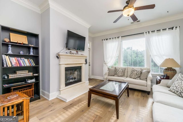 11 Perimeter Ctr E Unit 1412, Atlanta, GA 30346 - living room with wood finished floors, a glass covered fireplace, crown molding, and a ceiling fan