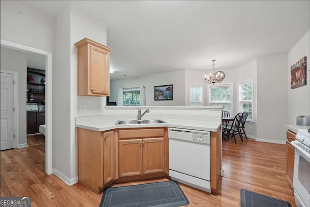 2545 Gatewater Ct, Cumming, GA 30040 - kitchen with white appliances, a sink, a peninsula, and light wood-type flooring