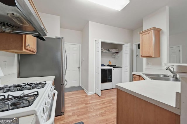 2545 Gatewater Ct, Cumming, GA 30040 - kitchen featuring a sink, separate washer and dryer, extractor fan, white gas range oven, and light wood-style floors