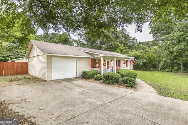 213 Feagin Mill Rd, Warner Robins, GA 31088 - ranch-style house featuring a porch, an attached garage, concrete driveway, and roof with shingles