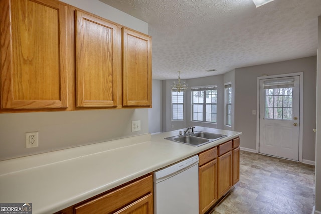5587 Strathmoor Manor Cir, Lithonia, GA 30058 - kitchen with white dishwasher, a sink, plenty of natural light, light countertops, and a textured ceiling
