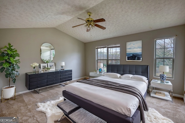 5587 Strathmoor Manor Cir, Lithonia, GA 30058 - carpeted bedroom with baseboards, vaulted ceiling, a textured ceiling, and a ceiling fan