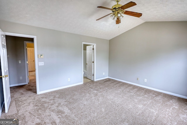 5587 Strathmoor Manor Cir, Lithonia, GA 30058 - carpeted spare room with a ceiling fan, a textured ceiling, baseboards, and lofted ceiling