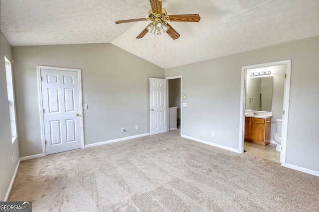 5587 Strathmoor Manor Cir, Lithonia, GA 30058 - unfurnished bedroom featuring light carpet, baseboards, lofted ceiling, and a textured ceiling