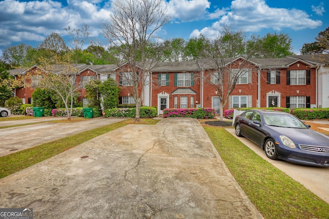 5587 Strathmoor Manor Cir, Lithonia, GA 30058 - townhome / multi-family property featuring brick siding and a residential view
