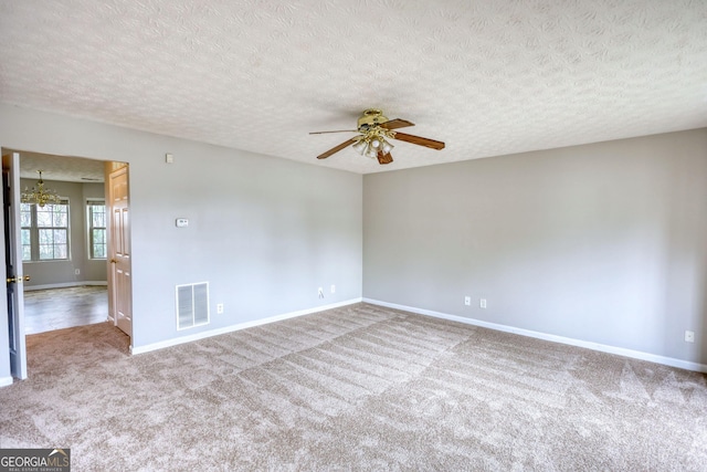 5587 Strathmoor Manor Cir, Lithonia, GA 30058 - carpeted spare room with baseboards, a ceiling fan, a chandelier, and a textured ceiling