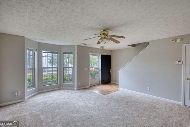 5587 Strathmoor Manor Cir, Lithonia, GA 30058 - carpeted empty room featuring baseboards, a ceiling fan, and a textured ceiling