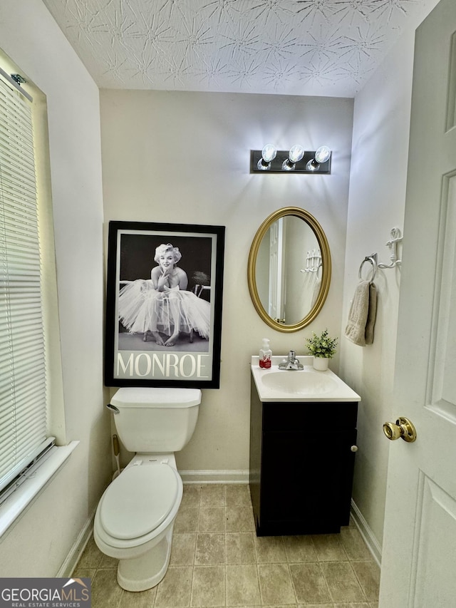 105 Avonwood Cir, Locust Grove, GA 30248 - bathroom featuring vanity, toilet, baseboards, and tile patterned flooring