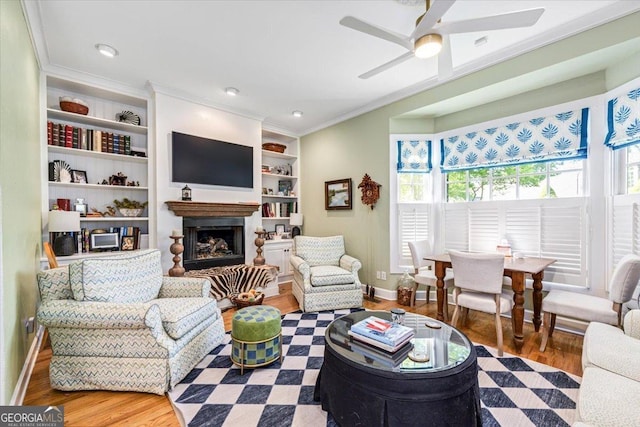 116 Maimont Cir, Macon, GA 31210 - living area with wood finished floors, ceiling fan, ornamental molding, a fireplace, and built in shelves