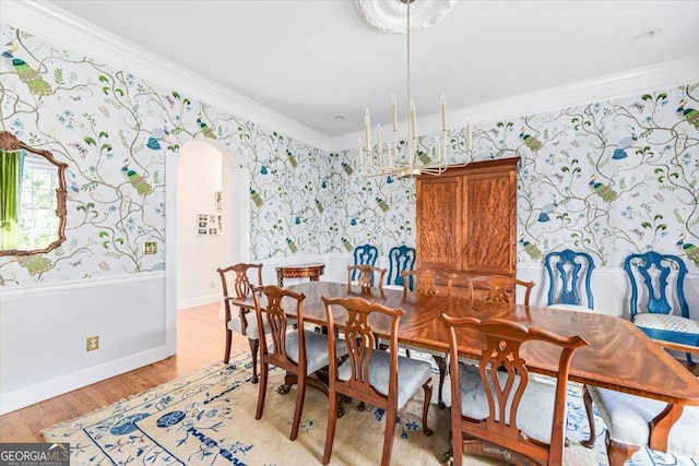 116 Maimont Cir, Macon, GA 31210 - dining area featuring crown molding, arched walkways, wallpapered walls, and light wood-style floors