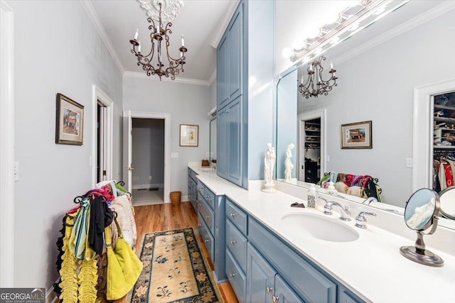 116 Maimont Cir, Macon, GA 31210 - full bath featuring a chandelier, vanity, a walk in closet, wood finished floors, and ornamental molding