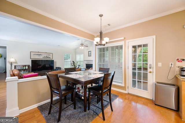 199 Eastham Ct, Suwanee, GA 30024 - dining room featuring a chandelier, light wood-style floors, crown molding, and baseboards