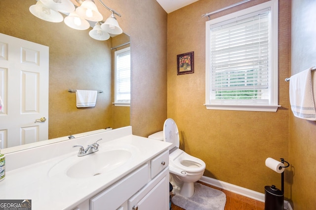 199 Eastham Ct, Suwanee, GA 30024 - half bath with toilet, vanity, wood finished floors, and baseboards