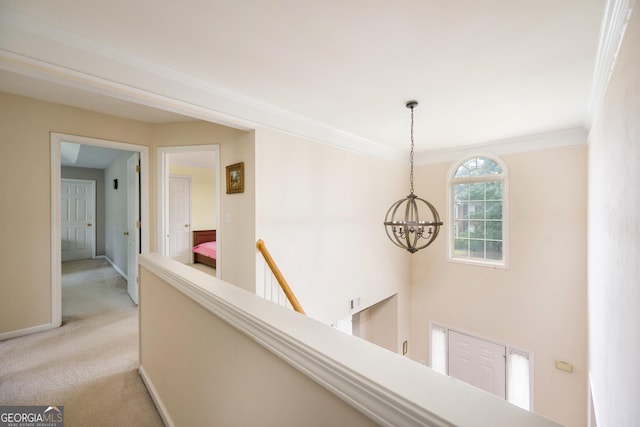 199 Eastham Ct, Suwanee, GA 30024 - corridor featuring a chandelier, light carpet, an upstairs landing, baseboards, and ornamental molding