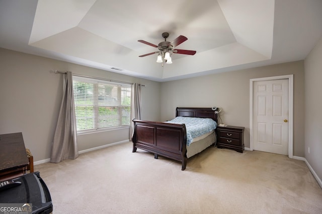 199 Eastham Ct, Suwanee, GA 30024 - bedroom featuring a tray ceiling, light carpet, baseboards, and a ceiling fan