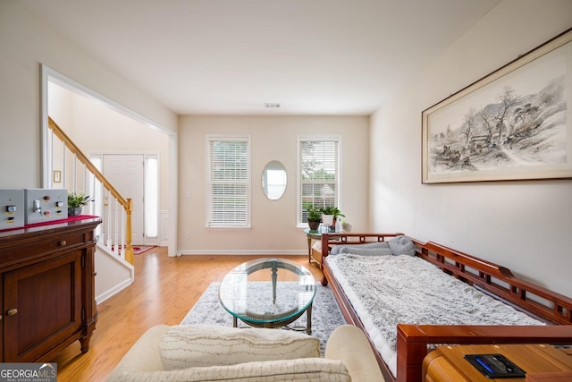 199 Eastham Ct, Suwanee, GA 30024 - living area with light wood finished floors, stairs, and baseboards
